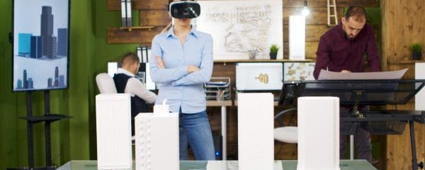 Female architects exploring virtual reality project of business buildings