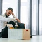 Unemployed man is with personal belongings after being fired